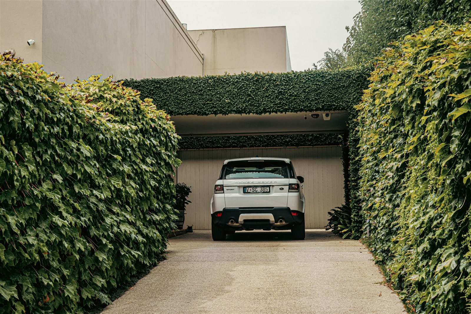 Range Rover Sport on a hedge-lined block-paved driveway, stock photo